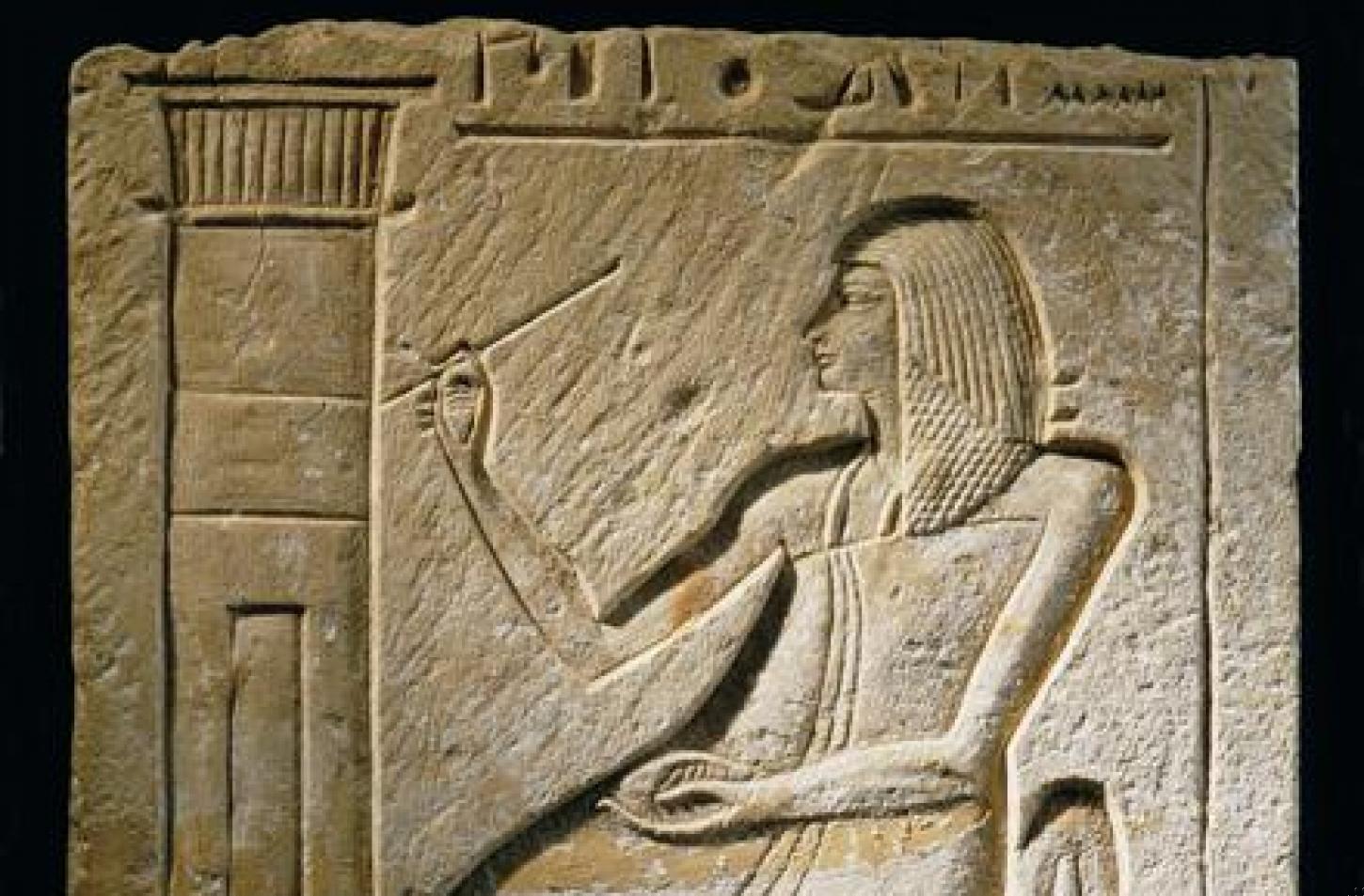 Fragment of a wall relief depicting a nobleman writing on the wall of his tomb